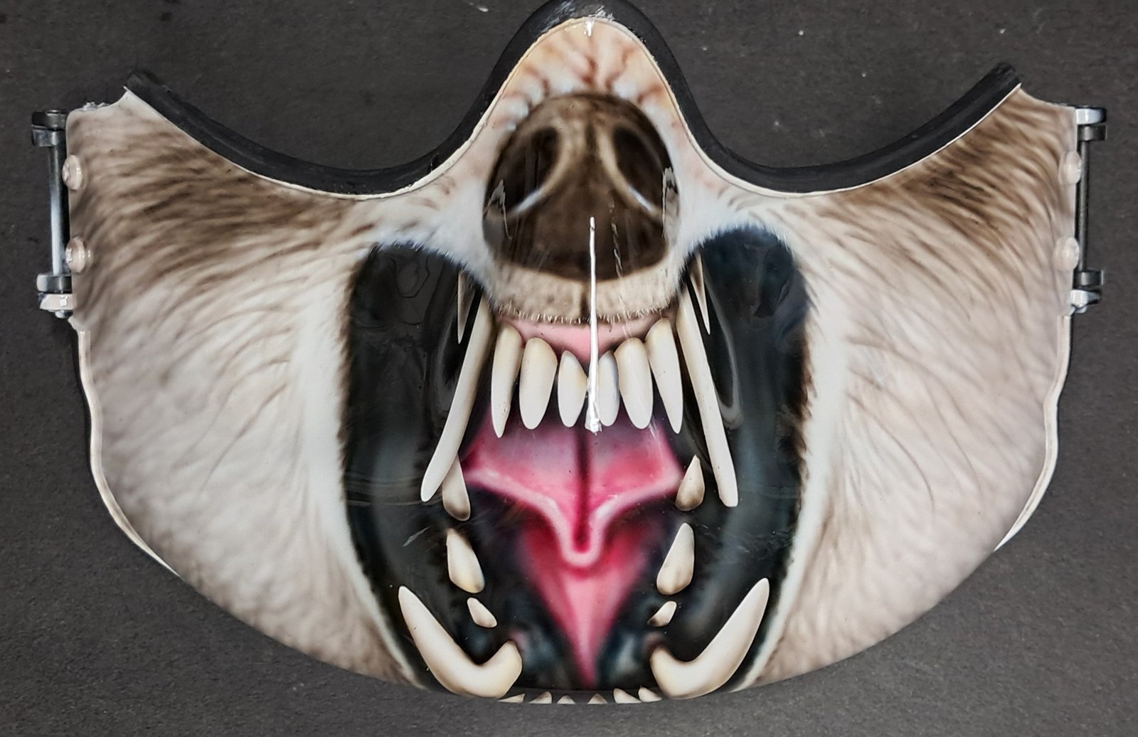 Military wolf snarling mask with fur and teeth.